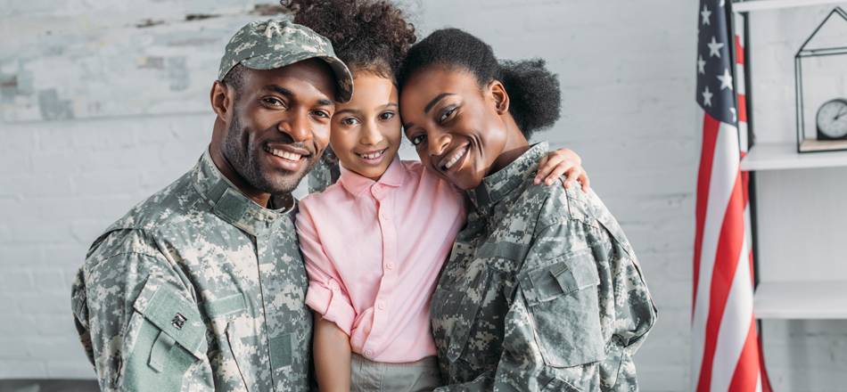 Small military family smiling in classroom
