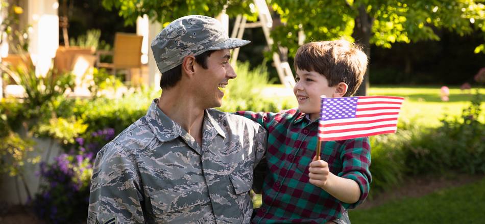 Military father with son holding small US flag