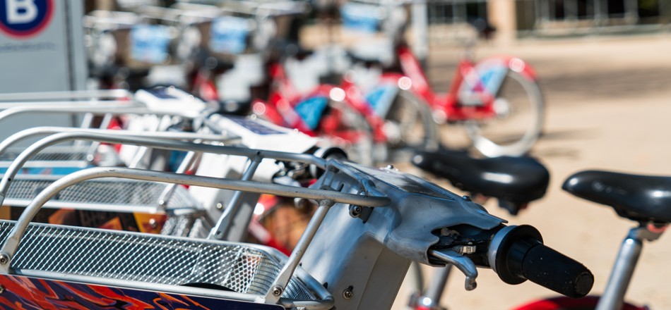 Close-up of bike seats and steering wheels in a bike-sharing system
