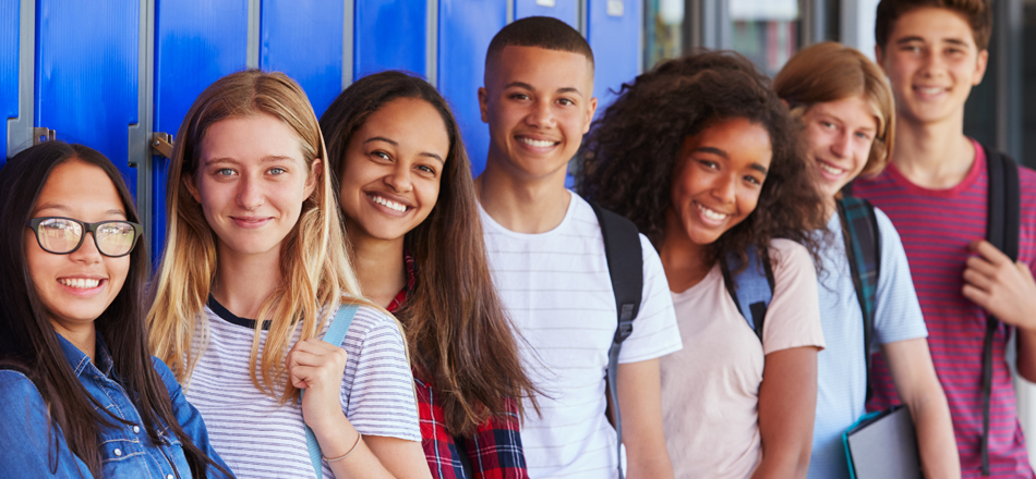 A group of high school students is smiling