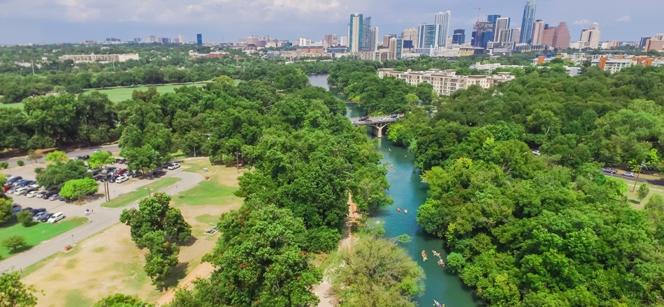 Aerial view of a lovely park and river alongside buildings in downtown Austin, Texas