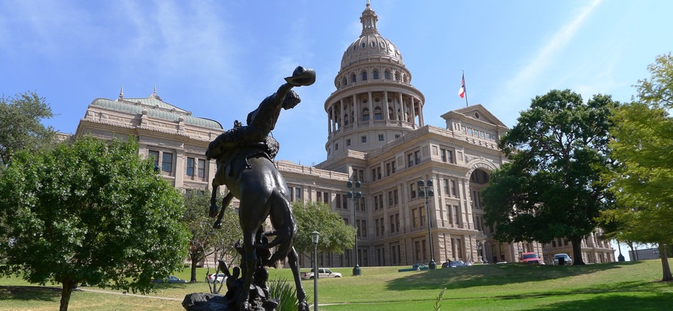 Austin University building alongside iconic cowboy monument