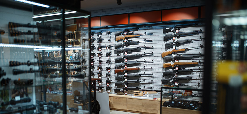 Wall with dozens of rifles in display