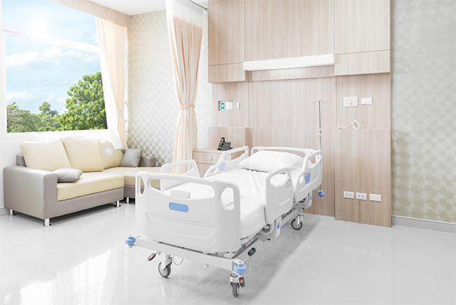 A hospital room with a couch and a chair