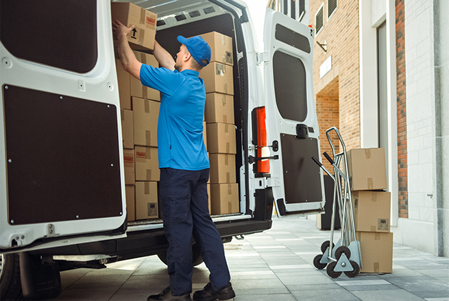 a guy arranging boxes in a van
