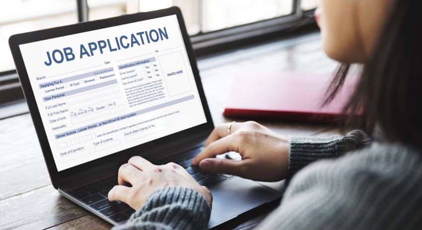 Woman hands filling out job application in laptop computer