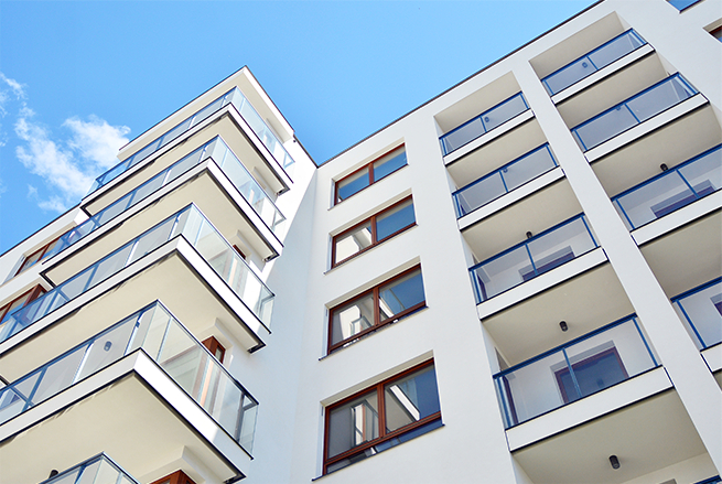 A tall white building with lots of windows