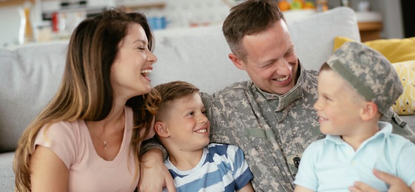 Happy soldier sitting on a couch