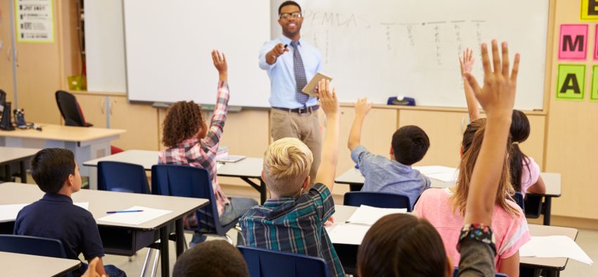 Kids raising hands to answer