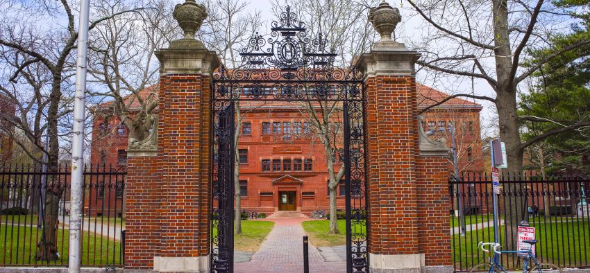 Entrance gate and East facade of Sever Hall at Harvard Yard in Harvard University in Cambridge, Massachusetts, MA, USA. It is used as the library, lecture hall and classroom for different courses.
