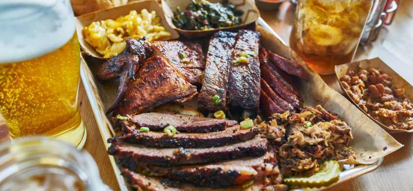 texas style bbq tray with smoked brisket, st louis ribs, pulled pork, chicken, hot links, and sides