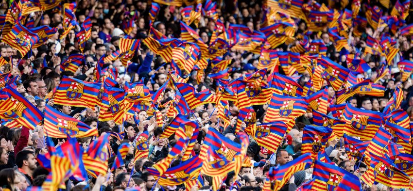 BARCELONA - APR 22: Fans waving flags during the UEFA Women's Champions League match between FC Barcelona and VfL Wolfsburg at the Camp Nou Stadium on April 22, 2022 in Barcelona, Spain.