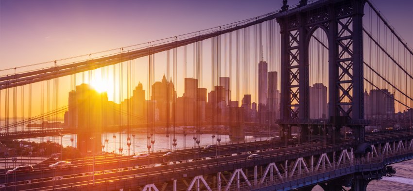 New York City - beautiful sunset over manhattan with manhattan and brooklyn bridge