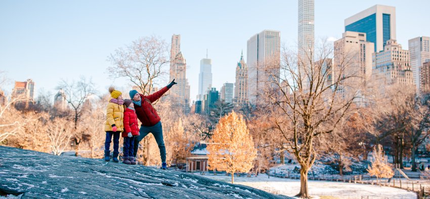 Family of father and little kids in Central Park on winter vacation in NYC