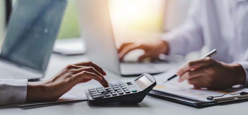 Portrait of a woman working on a tablet computer in a modern office. Make an account analysis report. real estate investment information financial and tax system concepts